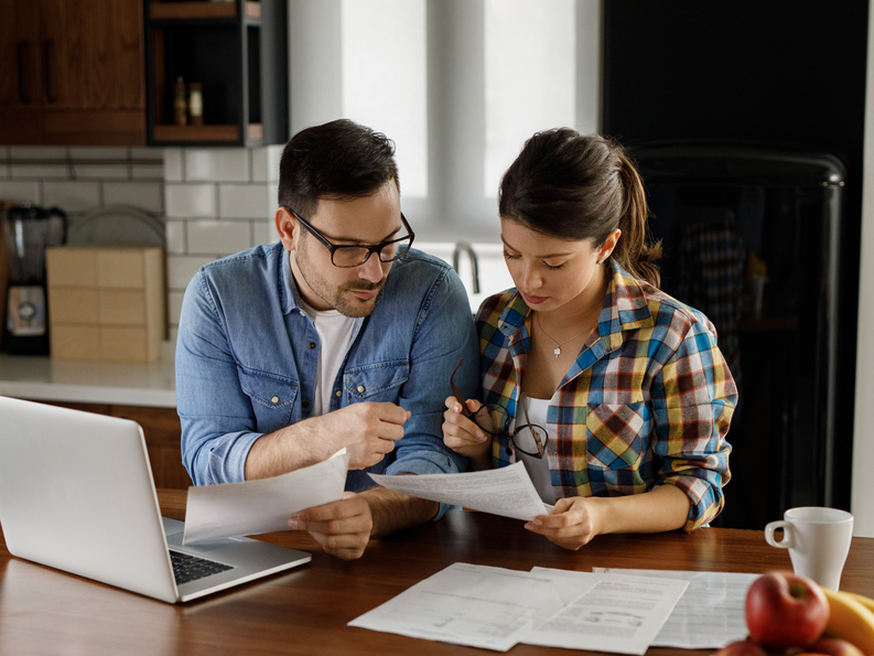 Couple looking at paper 1800x1350.png