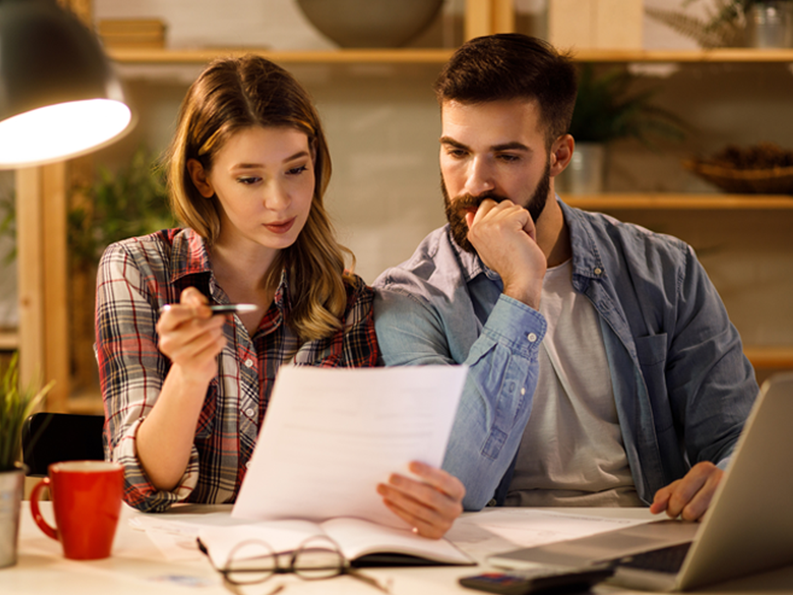 Couple reading bank statements 1800x1350.png