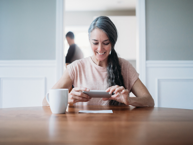 Lady using mobile check deposit 1800x1350.png