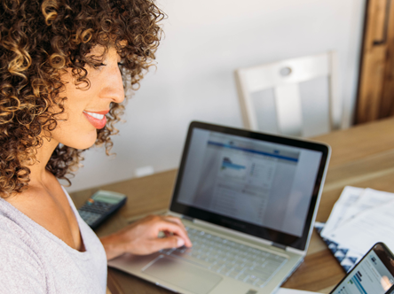 Woman on phone and laptop.png
